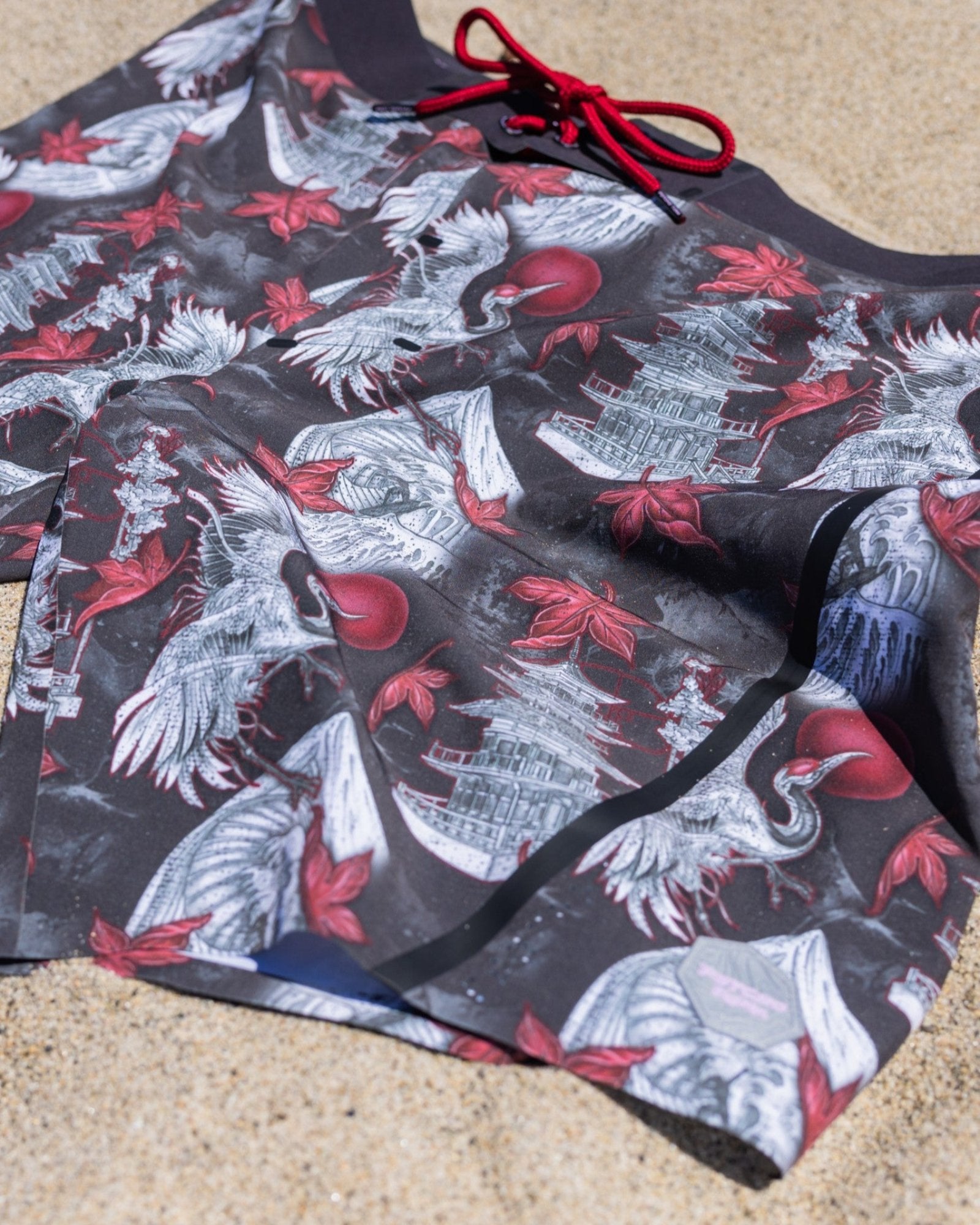 Stylish Men’s Board Shorts with 4-Way Stretch Technology on sand background detailed close up