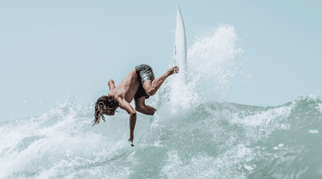 Titus Kaimana Santucci in water surfing shot